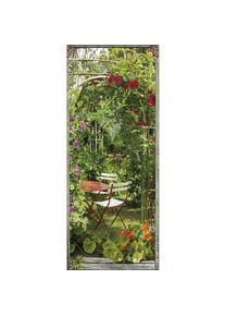 Sticker mural décoratif 204 cm x 83 cm, trompe l'oeil fleuri avec arche de capucine et rose trémière autour d'une table de jardin. - Vert